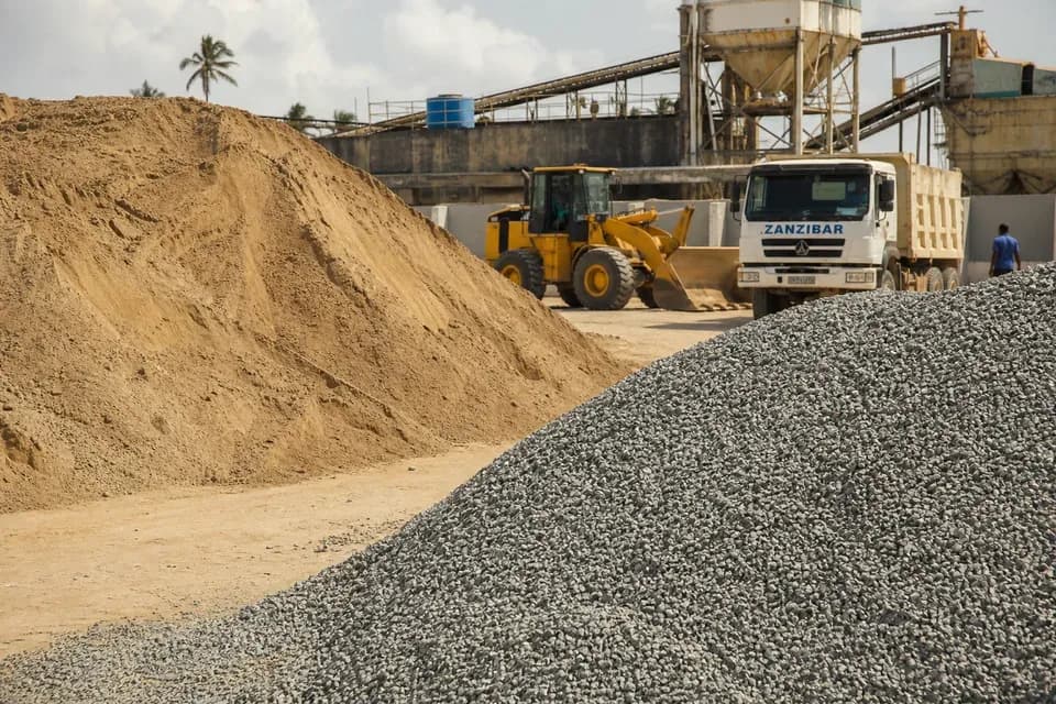 Sand and aggregate piles at a supply site