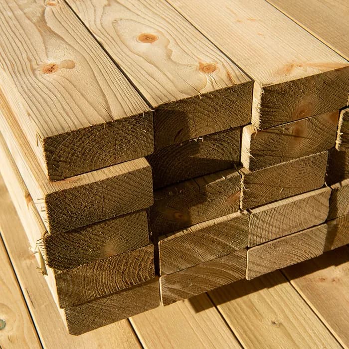 Close-up sawn timber and boards stacked under cover